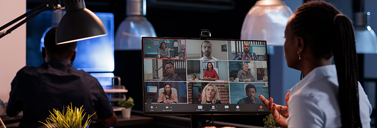 a women seen attending a virtual team meeting at her office 